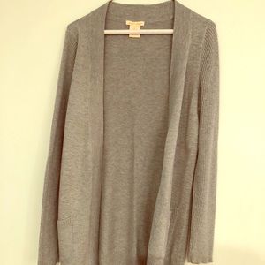 Long, light gray sweater.